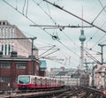 Suburban or Sbahn train of Berlin is approaching Friedrichstrasse station. Public transport in Berlin, visible typical houses and Royalty Free Stock Photo