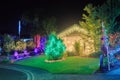 House and garden brightly lit with multicolored Christmas lights Royalty Free Stock Photo