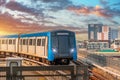 Subway modern high speed commuter train colorful sunset cityscape Royalty Free Stock Photo