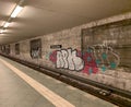 Subway station in Berlin, Germany with the wall beside the rails covered in graffiti spray paint