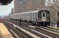 subway train on elevated track in the bronx with apartment buildings in the background (above ground metro line in nyc) Royalty Free Stock Photo