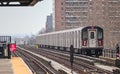 subway train on elevated track in the bronx with apartment buildings in the background (above ground metro line in nyc) Royalty Free Stock Photo