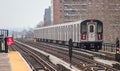 subway train on elevated track in the bronx with apartment buildings in the background (above ground metro line in nyc) Royalty Free Stock Photo