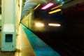 Subway train moves through a deserted platform leaving a blurred streak of light. Royalty Free Stock Photo