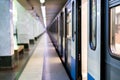 Subway train staying on a metro station with doors open with defocused background s Royalty Free Stock Photo