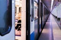 Subway train staying on a metro station with doors open with defocused background s Royalty Free Stock Photo