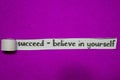 Succeed - Believe in Yourself, Inspiration, Motivation and business concept on purple torn paper Royalty Free Stock Photo