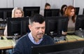 Succesful businessman foreground in busy open plan office Royalty Free Stock Photo