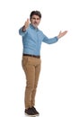 Succesful casual man giving a thumbs up and presenting Royalty Free Stock Photo