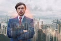 Succesful and rich. Close-up portrait of attractive man in suit keeping his arms crossed while standing against of