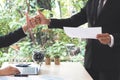 Success businessman partners making fist bump and thump up showing trust in team in office with laptop, document, calculator and Royalty Free Stock Photo