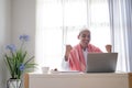 success businessman raise his arm while using laptop