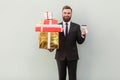 Success businessman toothy smile, holding box and credit card.