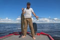 Success catfish fishing. Happy fisherman with big cat fish Royalty Free Stock Photo