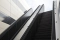 Success concept with bottom view on modern empty escalator to get out of the city with blue sky background.