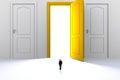 Success concept with businessman, Image of miniature businessman standing in front of open yellow door on white wall background Royalty Free Stock Photo