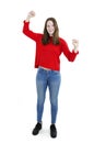 Success concept - extrovert young teenage girl cheering with both hands raised expressing her achievement and happiness.