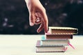 Success concept with fingers climbing stairs made of books stack