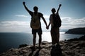 Success concept. Hiker with backpack standing on top of a mountain with raised hands and enjoying view Royalty Free Stock Photo