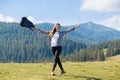 Success concept. Hiker woman cheering elated and blissful with arms raised in sky after hiking to mountain Royalty Free Stock Photo