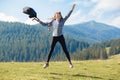 Success concept. Hiker woman cheering elated and blissful with arms raised in sky after hiking to mountain Royalty Free Stock Photo