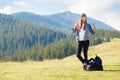 Success concept. Hiker woman cheering elated and blissful with arms raised in sky after hiking to mountain Royalty Free Stock Photo