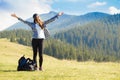 Success concept. Hiker woman cheering elated and blissful with arms raised in sky after hiking to mountain Royalty Free Stock Photo