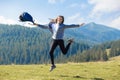 Hiker woman cheering elated and blissful with arms raised in sky after hiking to mountain top Royalty Free Stock Photo