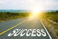 Success, concept photo of asphalt road. Motivational inscription on the road going forward. The beginning of a new path. A Royalty Free Stock Photo