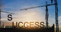 Success concept, Silhouette cranes and under construction building with SUCCESS over sunset sky Royalty Free Stock Photo