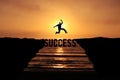 Success concept with silhouette of a person jumping over the cliff at sunset beach. Challenge and business man ways Conceptual Royalty Free Stock Photo