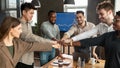 Diverse business people giving fist bump in circle at office Royalty Free Stock Photo