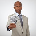 This success could be yours too. A handsome businessman showing you a wad of cash while isolated on a white background.