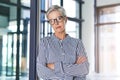 Success is earned not handed down. Portrait of an attractive mature businesswoman posing with her arms folded in her Royalty Free Stock Photo