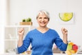 Happy senior woman celebrating success in kitchen Royalty Free Stock Photo