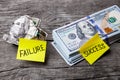 Success and failure in business, choice of ways, concept. Office stickers on dented banknote and pile of dollars Royalty Free Stock Photo