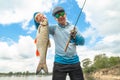 Success fishing. Fisherman with chub fish at wild river