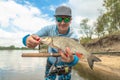 Success fishing. Fisherman with chub fish at wild river