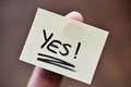 Success / Goal Concept - Index Finger Holding Note With Handwritten YES Word