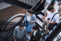 Success happens when you combine action with ambition. a group of businesspeople walking up the stairs in a modern Royalty Free Stock Photo