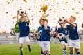 Success of kids football team in tournament final game. Happy boys in school sports team winning soccer championship