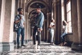 Success and knowledge helps us on the exam. Happy young students standing at the university hall and chatting Royalty Free Stock Photo