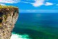 Young travel girl sits on the edge of a cliff on background amazing nature landscape tropical island Bali, Indonesia Royalty Free Stock Photo