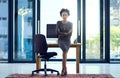 Success is my number one priority. Portrait of a confident young businesswoman leaning against a desk at work. Royalty Free Stock Photo