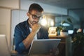 Success never came easy. a handsome young businessman working late at night on his tablet in a modern office. Royalty Free Stock Photo