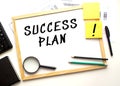 SUCCESS PLAN text is written on a white office board. Work table with office supplies Royalty Free Stock Photo