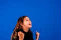 Success. Portrait winning successful little girl happy ecstatic celebrating being winner isolated blue background Royalty Free Stock Photo