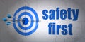 Protection concept: target and Safety First on wall background Royalty Free Stock Photo