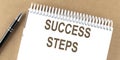 SUCCESS STEPS text on a notepad with pen, business Royalty Free Stock Photo