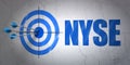 Stock market indexes concept: target and NYSE on wall background